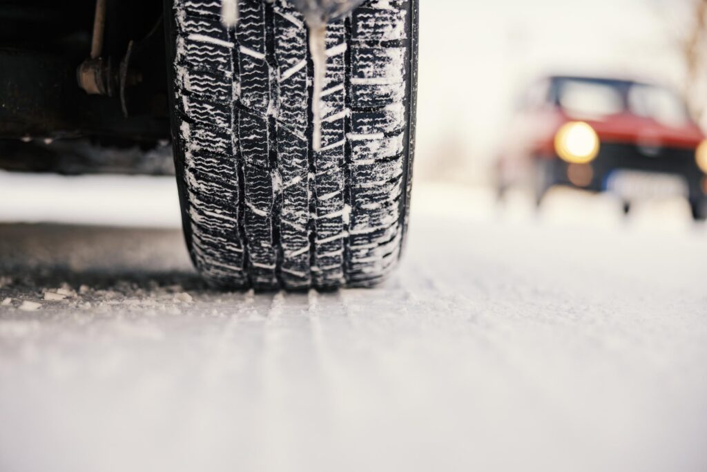 Winter Tire Gripping Snow on Cold Road